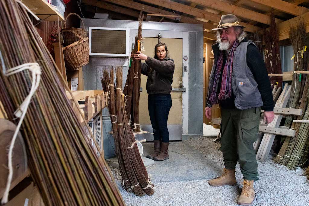  

Quinn weighs a bundle of willow to buy from Howard Peller (right) in Roseville, Ohio, on April 1, 2022. Peller owns one of the few willow farms in the country where he weaves art from the willow he grows and is Quinn’s main supplier of willow.  