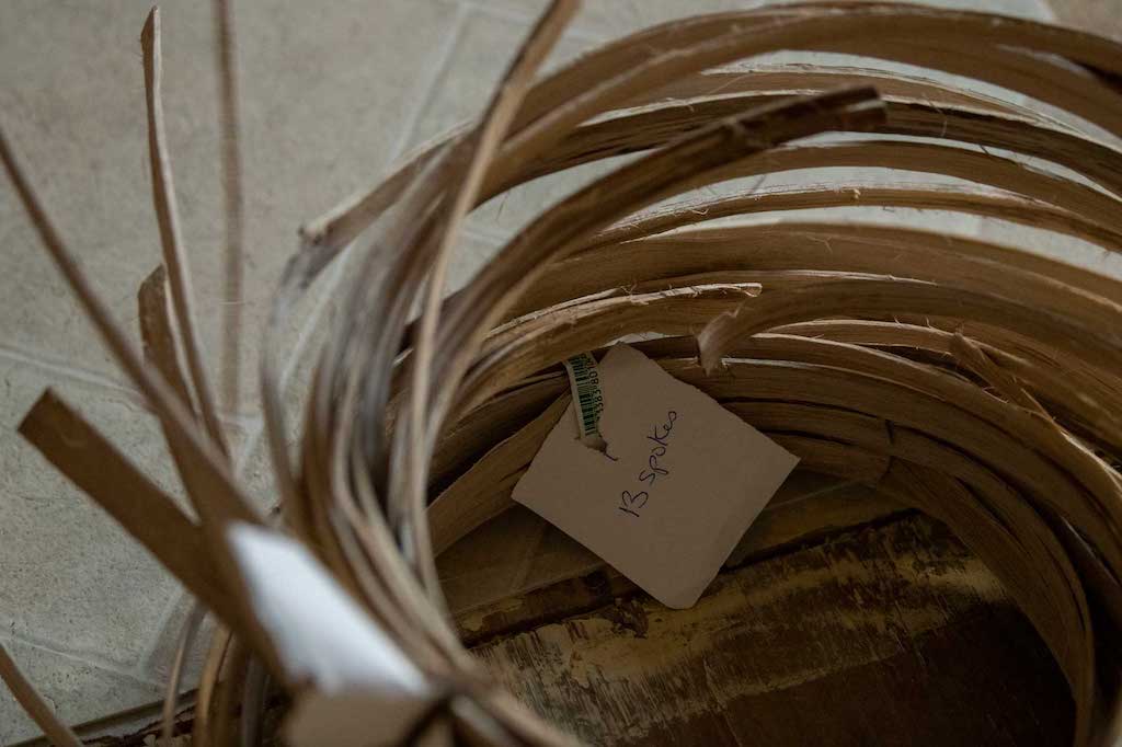 A bundle of long thin pieces of wood known as ‘spokes’ sit on Quinn’s living room floor on Feb. 22, 2022. Spokes are one of the key materials used in basket weaving. Prior to being woven into baskets, spokes are soaked in a bucket of water to increase flexibility and then shaved down.   
