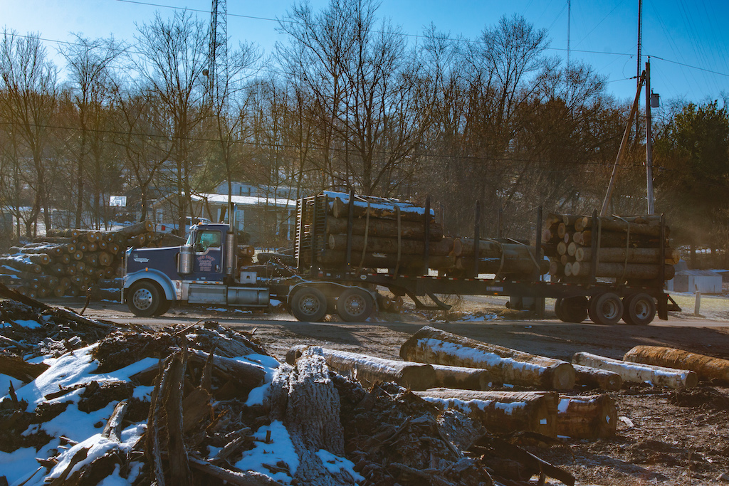 Trucks carrying logs from the surrounding woods arrive at Crownover. Around 20 of these trucks come by each day to drop off wood. McArthur, Ohio.