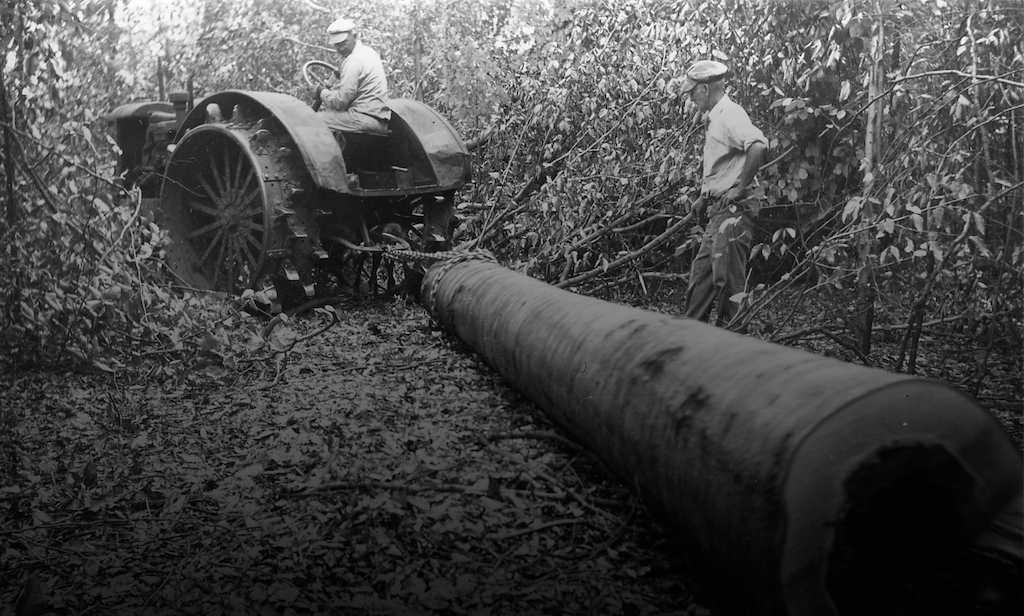 Wheeled tractor pulling Beech logs pulled by a chain, a process known as skidding - Image from 1945 | Courtesy of the Southeast Ohio History Center