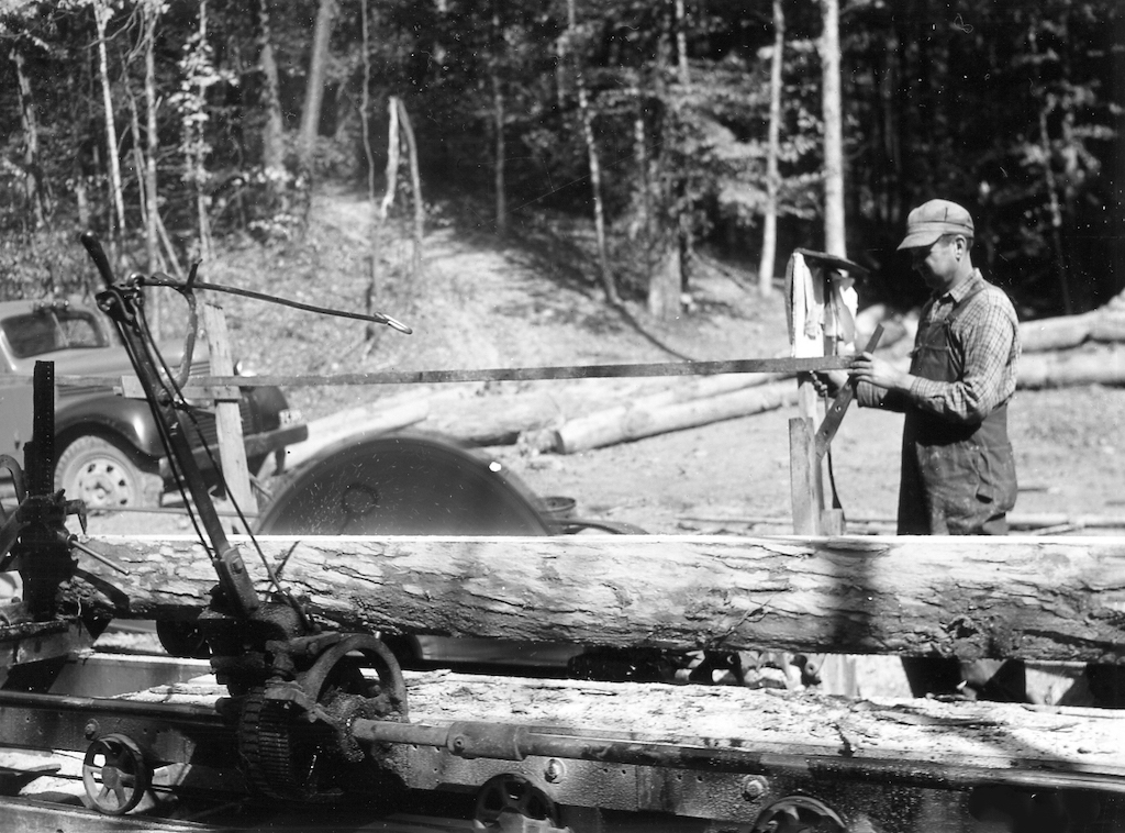 Wm. Arbaugh logging operation sawing a white oak log from Wayne National Forest on the portable sawmill - Image from 1940. (<i>Courtesy of the Southeast Ohio History Center</i>)